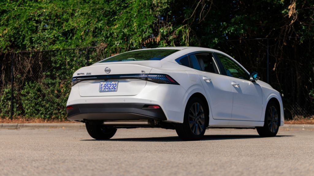 Rear exterior view of a new Nissan Sentra parked in an empty lot