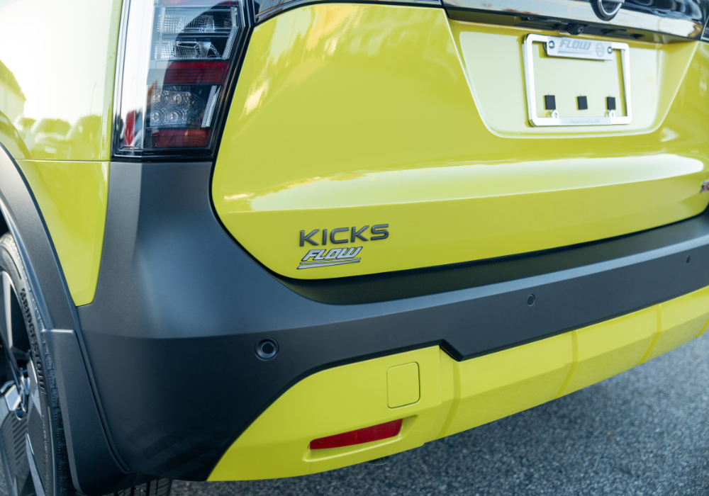 Close up of the exterior of a yellow Nissan Kicks for sale. 