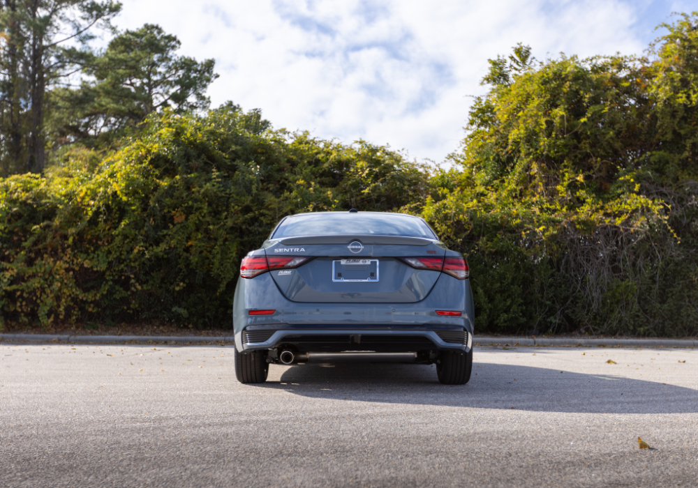 Rear exterior view of a new Nissan Sentra parked in an empty lot