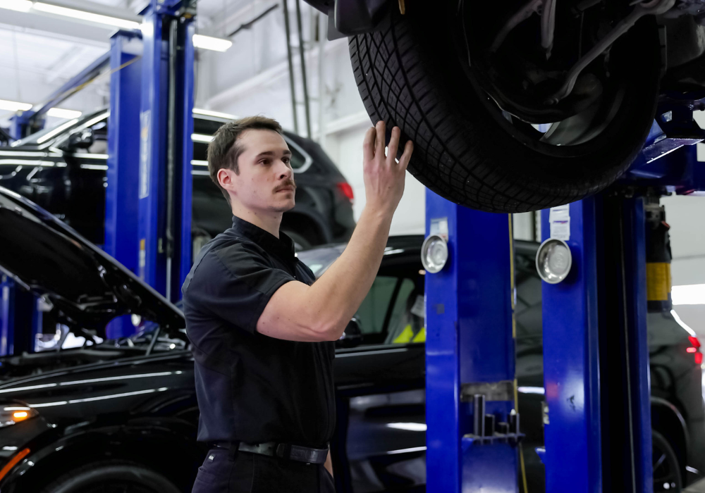 Service technician working on a Nissan vehicle at Flow Nissan of Fayetteville